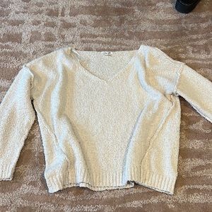 Woman’s beige V neck sweater